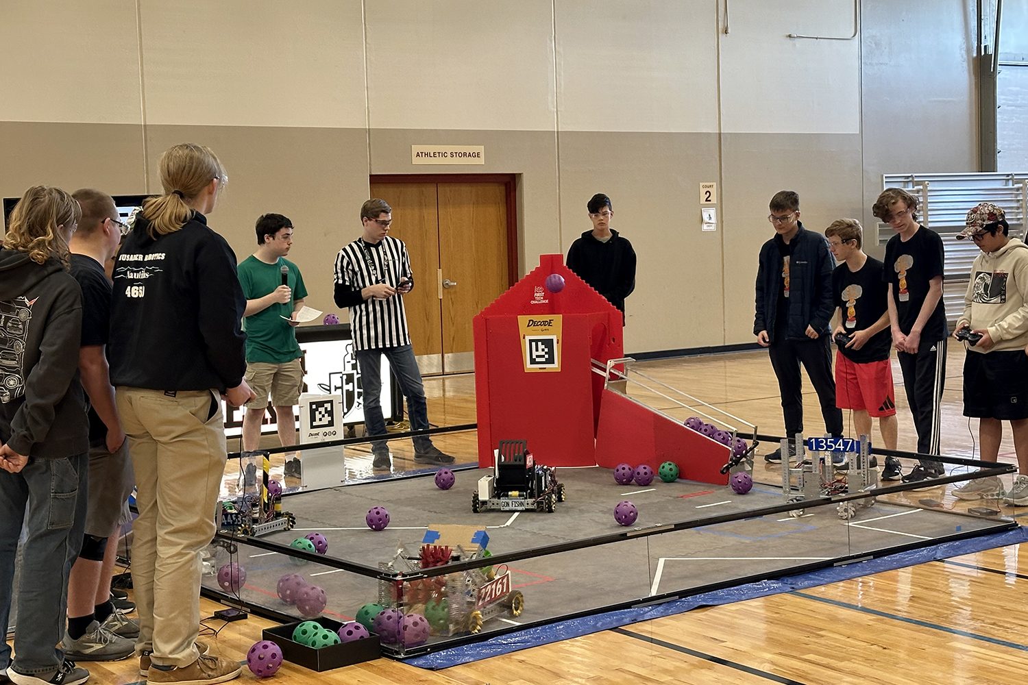 Crusader Robotics students driving robots on the competition field