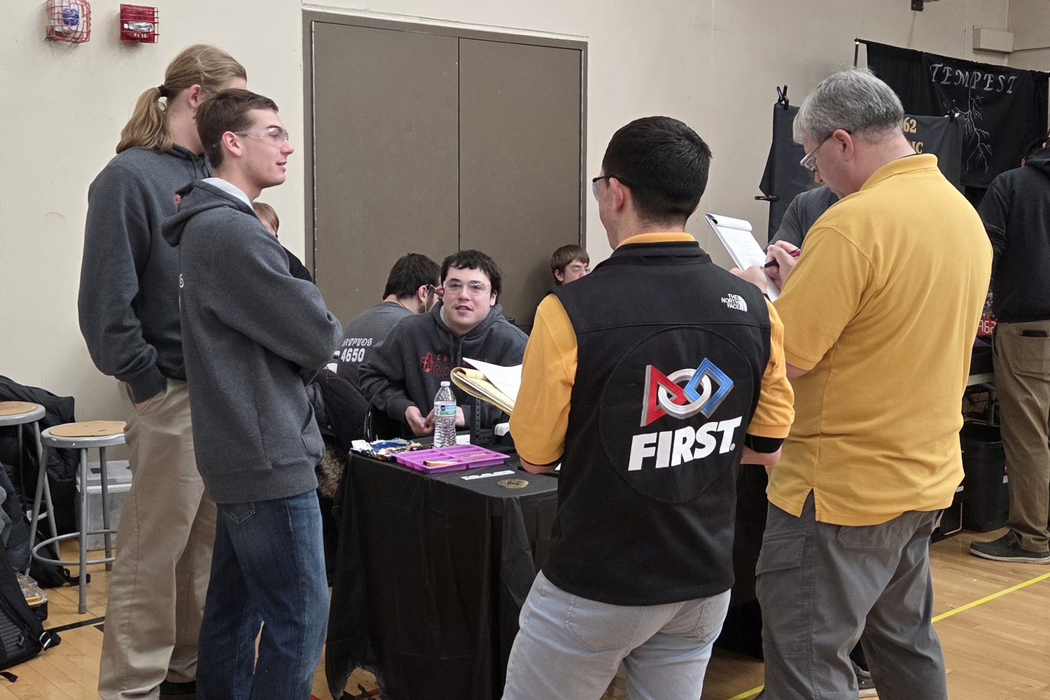 A student explaining the robot to FIRST judges