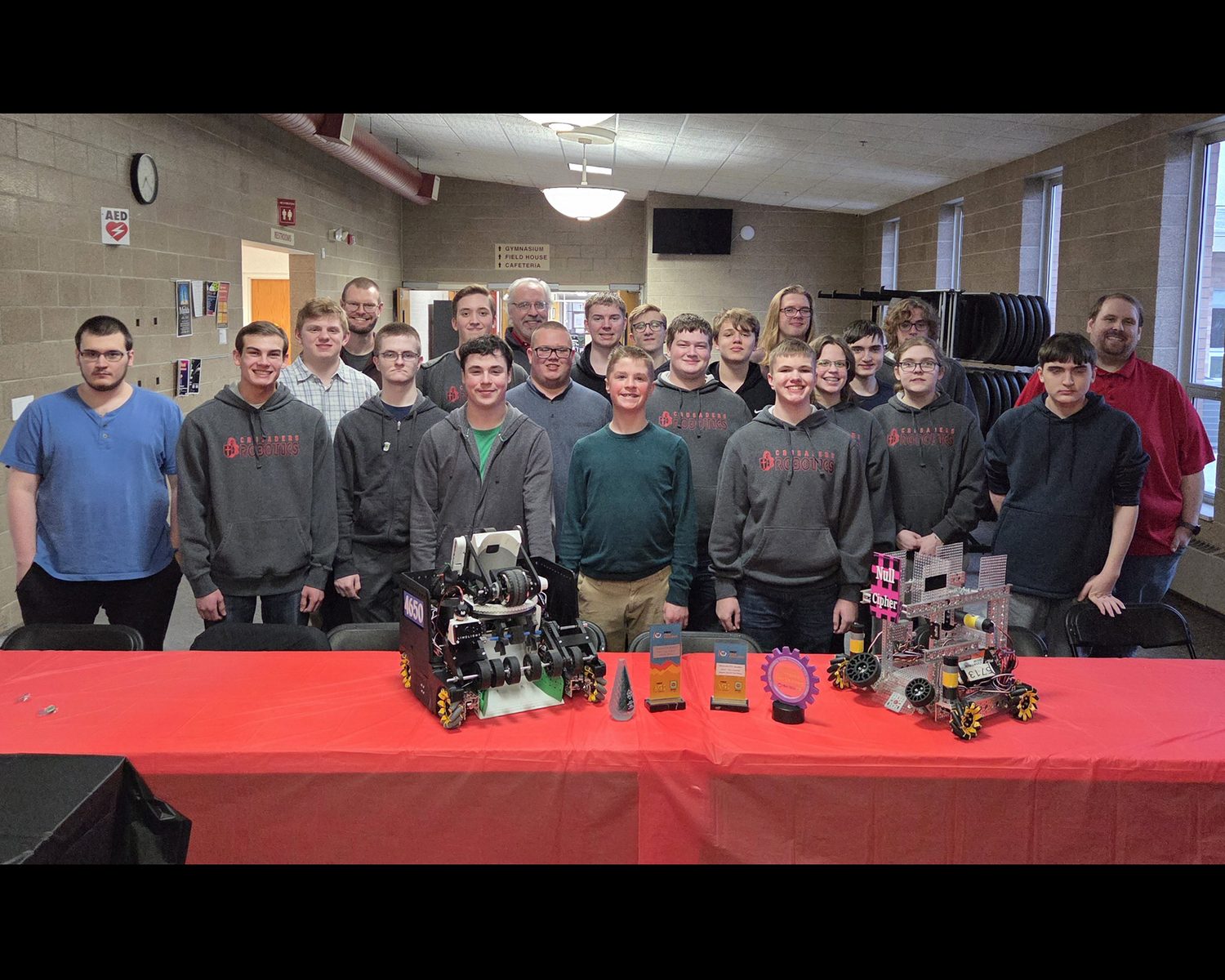 The whole robotics program with their robots at the banquet